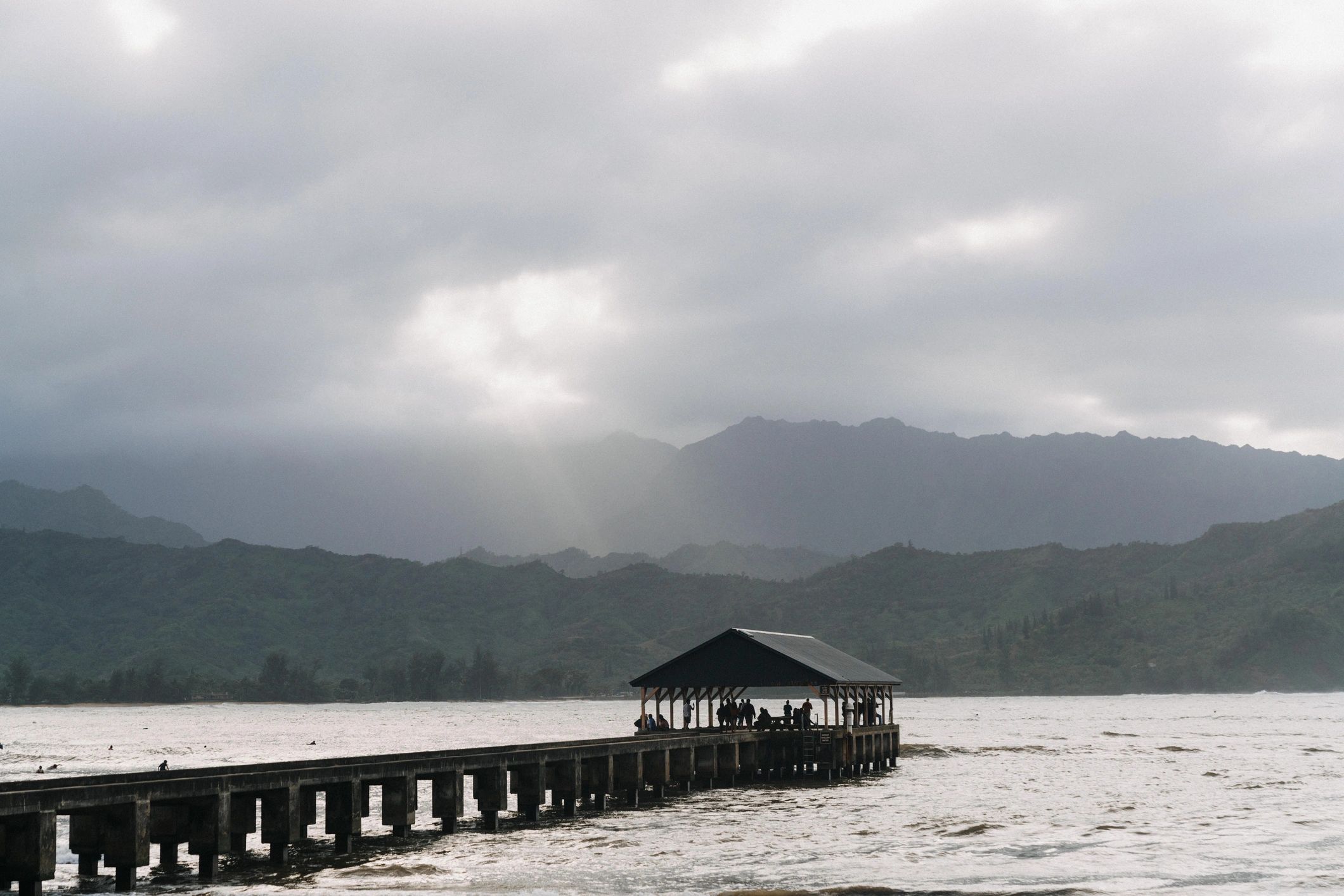 Hawaii beach scene with pier and shoreline